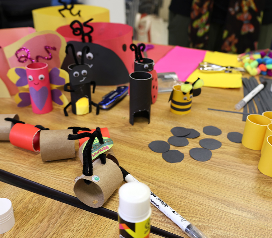 a pack of crayons and coloring sheets of bugs.