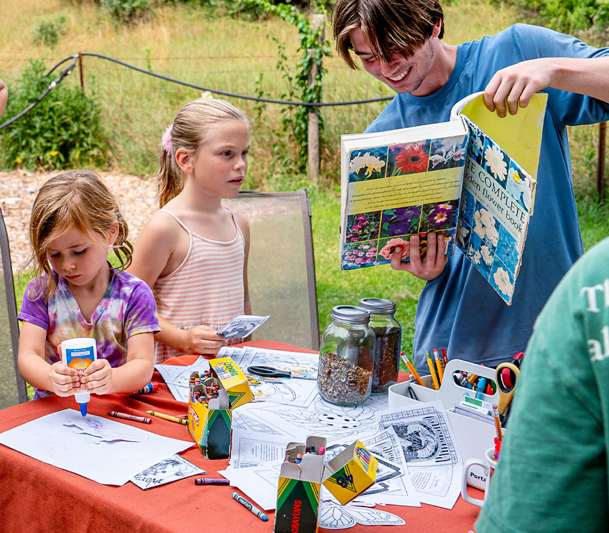 kids at a table doing crafts.